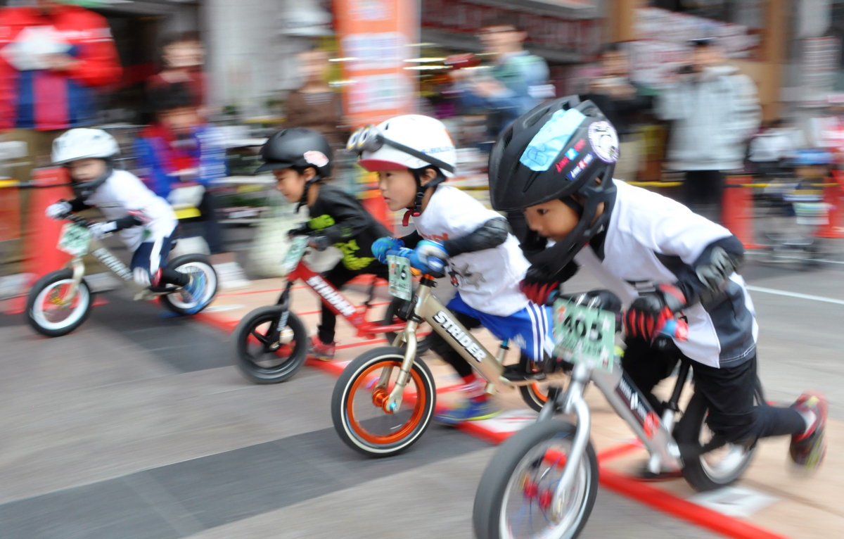 キックバイク大会で、力強くスタートダッシュする男の子たち